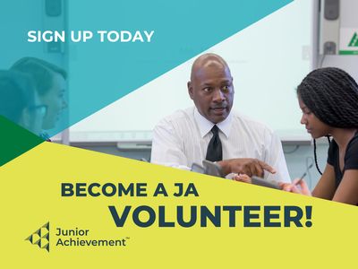 Male volunteer with students in a classroom. Text reads Sign Up Today Become A JA Volunteer!